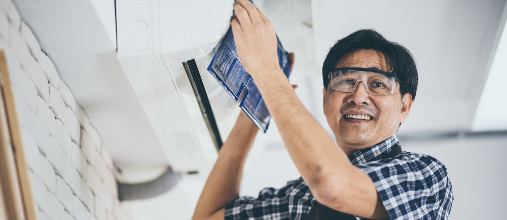 aircon technician servicing an ac unit